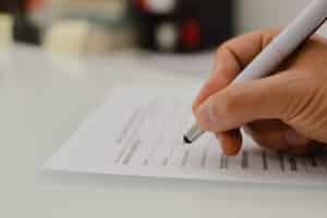Closeup,Of,Hand,Writing,Filling,Job,Or,Service,Application,Form