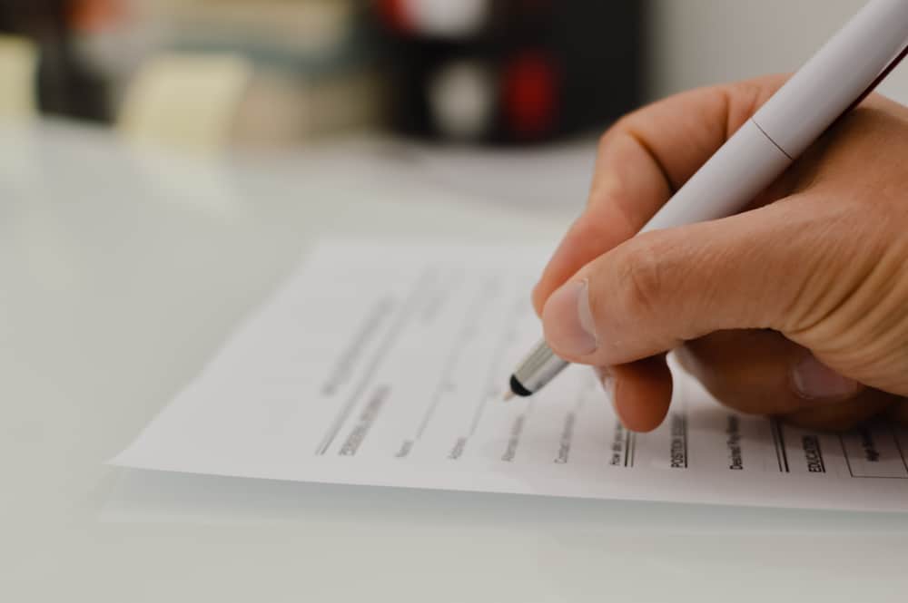 Closeup,Of,Hand,Writing,Filling,Job,Or,Service,Application,Form